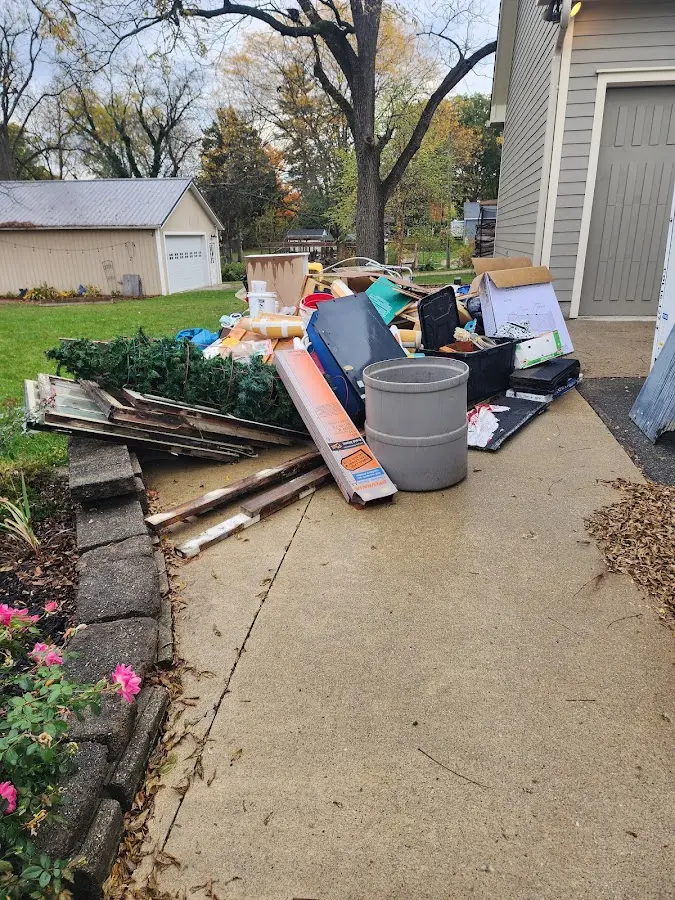 Dumpster being loaded with debris for 3 Yard Dumpster Rental in River Road